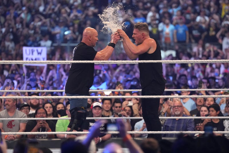 Stone Cold Steve Austin (left) and Pat McAfee toast beer during WrestleMania at AT&T Stadium