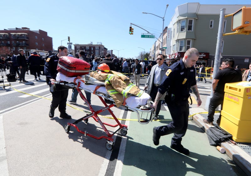 EMT's from the New York City Fire Department work near the scene of a subway shooting in Brooklyn April 12, 2022.