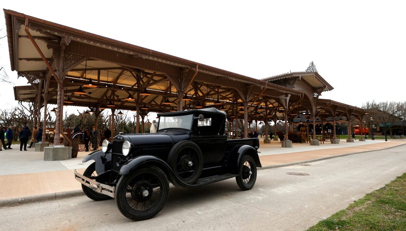 A Ford Model T is parked in front of the historic Detroit Central Market at Greenfield Village