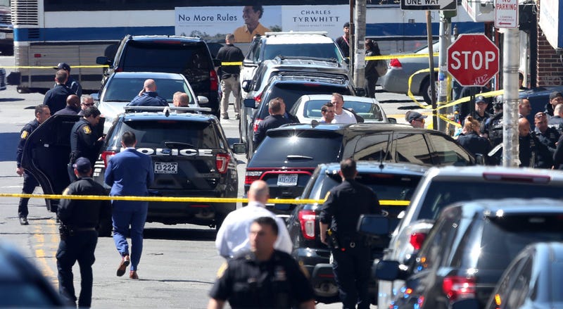 Several Yonkers police officers converge on the intersection of Elm Street and Linden Street in the Nodine Hill section of Yonkers, following a police involved shooting April 20, 2022.