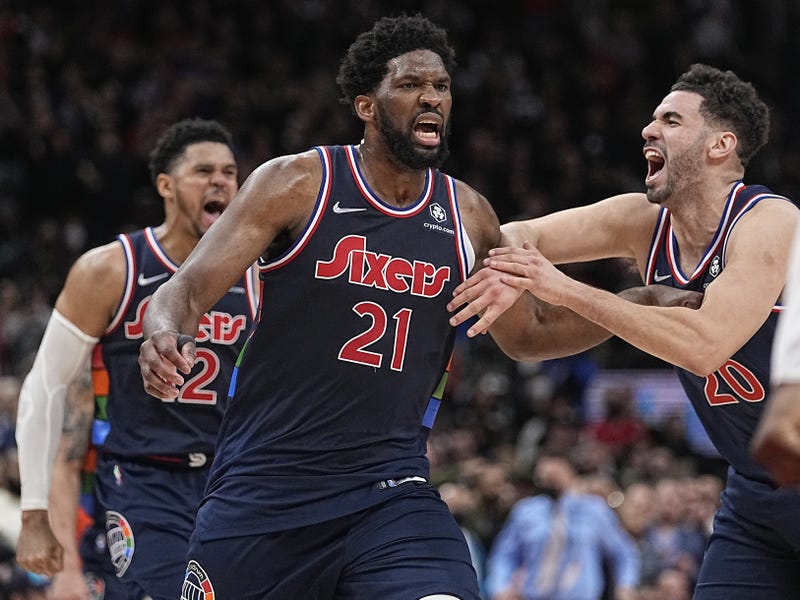 Philadelphia 76ers forward Georges Niang (20) congratulates center Joel Embiid (21) 