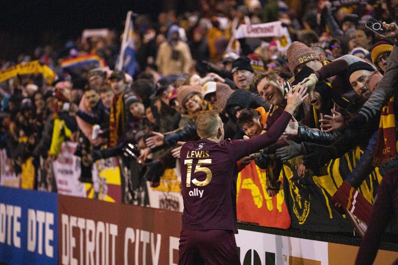 Detroit City FC's Matt Lewis celebrates with fans after beating Columbus Crew of MLS