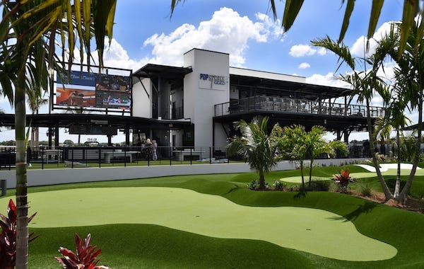 PopStroke is a golf and outdoor dining venue that features two 18-hole putting courses designed by Tiger Woods