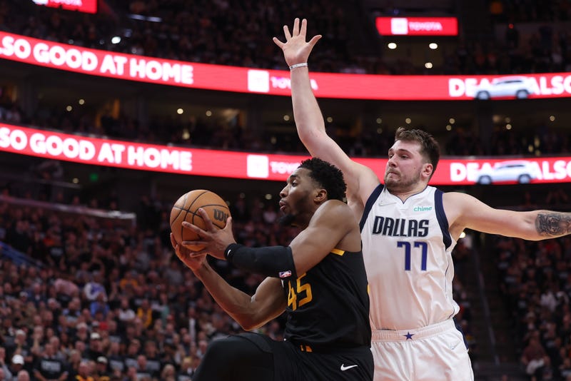 Newly acquired Donovan Mitchell (45) drives the ball past Dallas Mavericks guard Luka Doncic (77) in the fourth quarter during game six of the first round for the 2022 NBA playoffs at Vivint Arena.