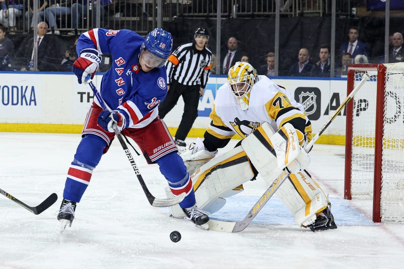  New York Rangers center Andrew Copp (18) plays the puck in front of Pittsburgh Penguins goaltender Louis Domingue (70) during the third overtime 