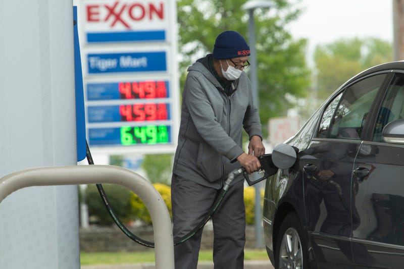 Ahmed Benameur, gas station attendant, pumps gas at the Route 4 Exxon station in Paramus, N.J. on Wednesday May 11, 2022.
