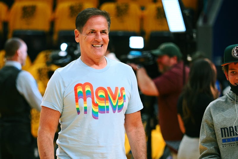 ; Dallas Mavericks majority owner Mark Cuban smiles while walking on the court 