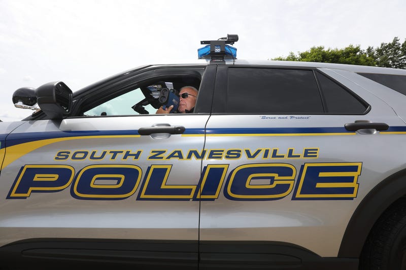 South Zanesville Police Chief Mark Ross monitors traffic on Maysville Pike. He said some money intended for equipment purchases is now going to the gas budget.