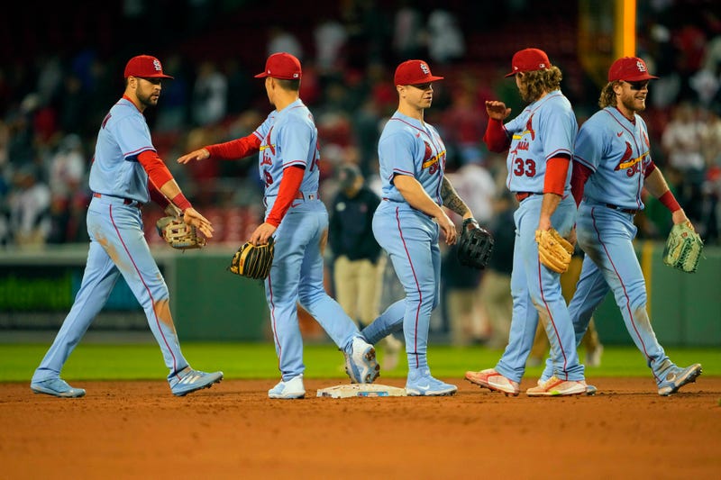 St. Louis Cardinals right fielder Dylan Carlson (3) and shortstop Tommy Edman (19) and left fielder Tyler O'Neill (27) and second baseman Brendan Donovan (33) shake hands after defeating the Boston Red Sox during the ninth inning at Fenway Park.