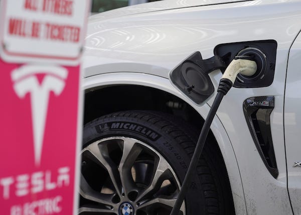 Tesla being charged at power station