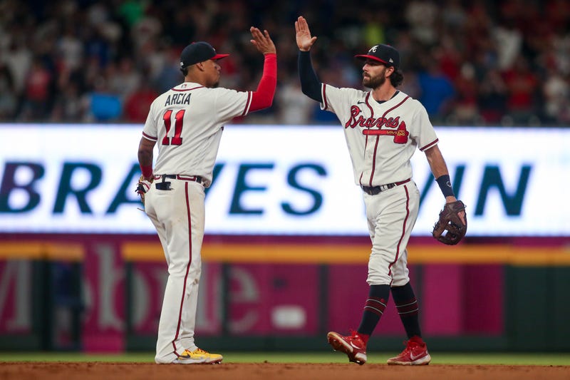 Jun 25, 2022; Atlanta, Georgia, USA; Atlanta Braves second baseman Orlando Arcia (11) and shortstop Dansby Swanson (7) celebrate after a victory against the Los Angeles Dodgers at Truist Park.