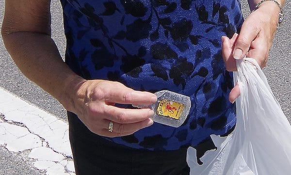 Woman holding empty mini bottle of Fireball