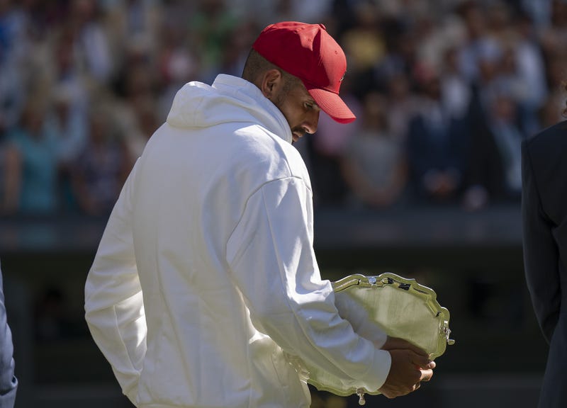 Nick Kyrgios (AUS) takes a look at his finalist plate after the men s final against Novak Djokovic