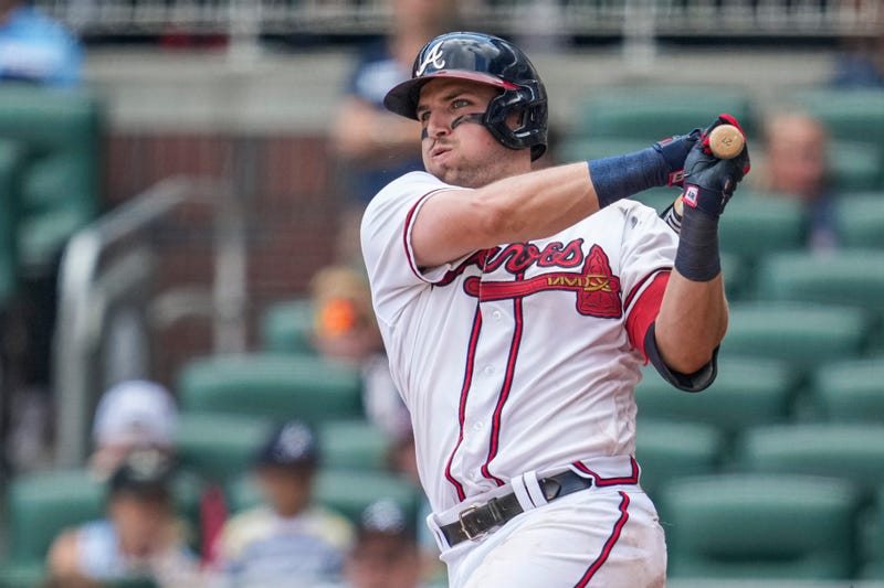 Jul 10, 2022; Cumberland, Georgia, USA; Atlanta Braves third baseman Austin Riley (27) drives in the winning run with a base hit against the Washington Nationals during the twelfth inning at Truist Park.