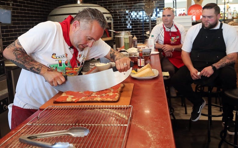 Tony Gemignani slices a pizza for those taking his master class at Sourdough Willy's in Kingston on Tuesday, July 12, 2022