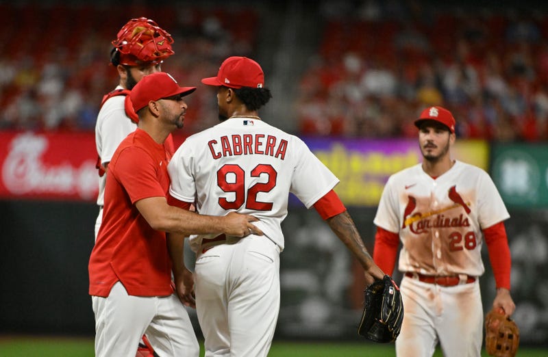 St. Louis Cardinals manager Oliver Marmol (37) talks with relief pitcher Genesis Cabrera (92) as he removes him from the game during the ninth inning against the Cincinnati Reds at Busch Stadium.