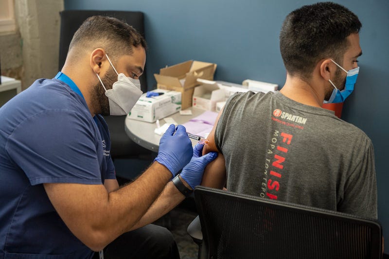 Nurse Ismael De Olveira administers a monkeypox vaccine at the JRI Health state backed monkeypox vaccination site in Framingham, July 25, 2022