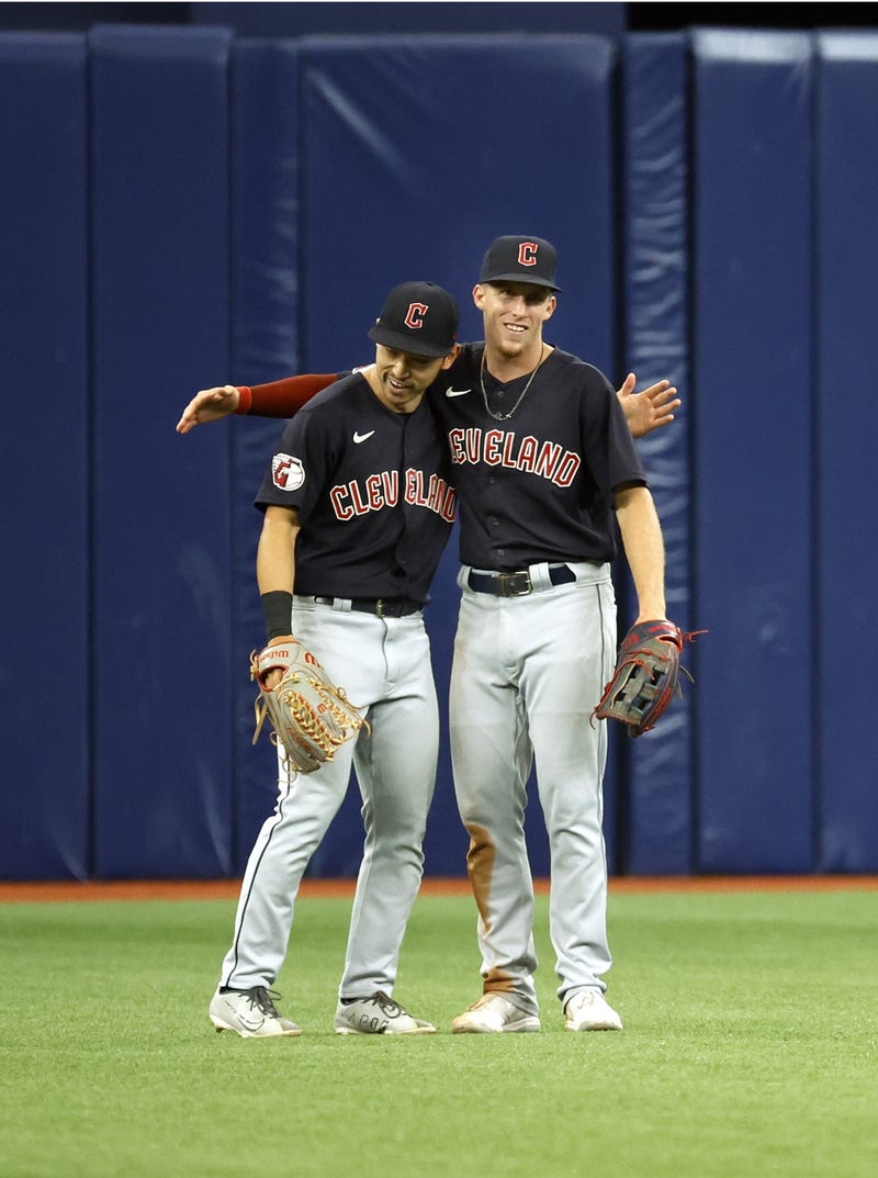 Cleveland Guardians left fielder Steven Kwan (38) and center fielder Myles Straw (7) celebrate as they beat the Tampa Bay Rays at Tropicana Field. 
