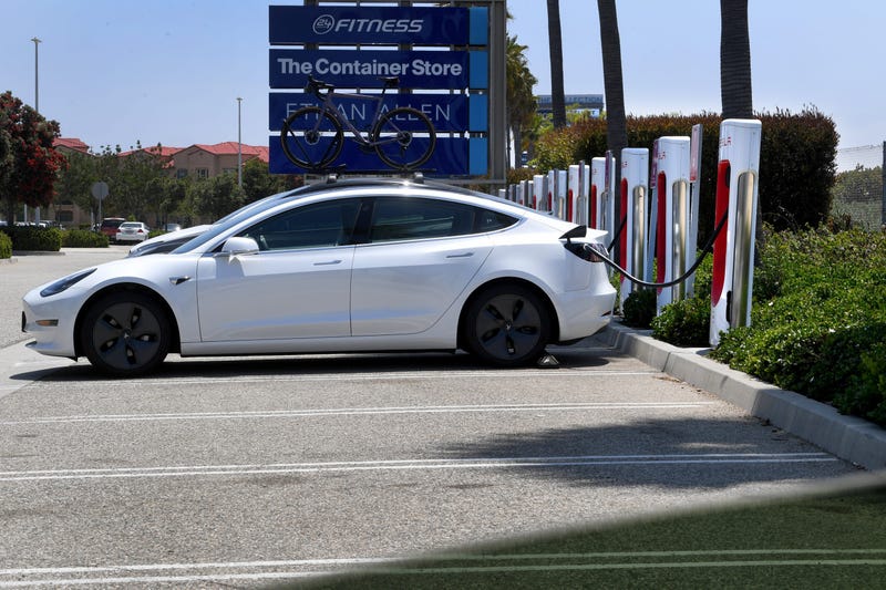 A Tesla plugs into an electric vehicle charging station in Oxnard, California
