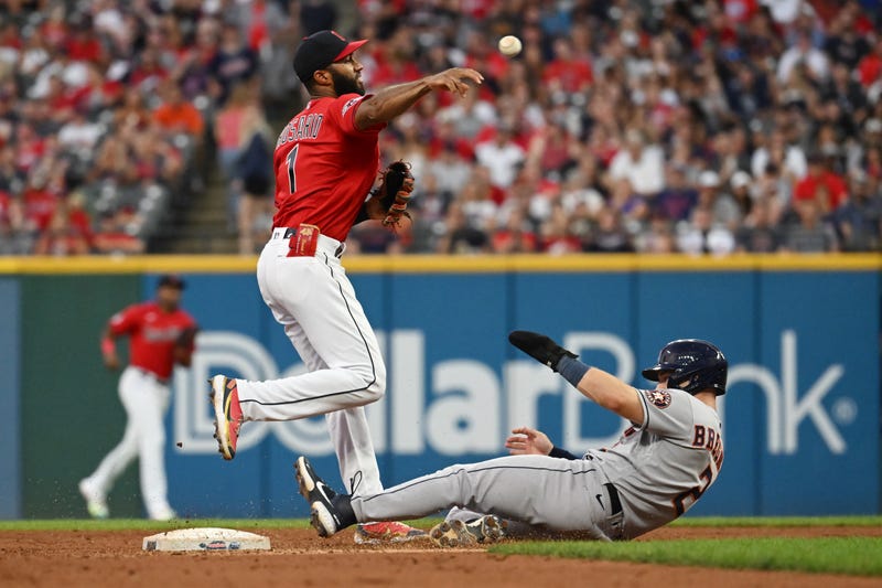Cleveland Guardians shortstop Amed Rosario (1) forces out Houston Astros third baseman Alex Bregman (2) during the fifth inning at Progressive Field.