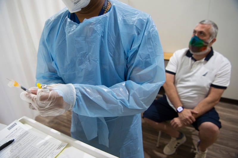Mike Smith, of East Brunswick waits as RN Eldho Itoop draws a syringe of the Monkeypox vaccine in Paramus, N.J. on Thursday Aug. 4, 2022.