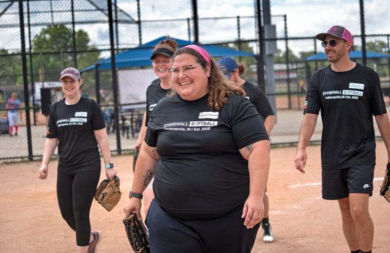 Annie Nelson, center, and her Bunts & Grunts softball teammates leave the field after winning their game.