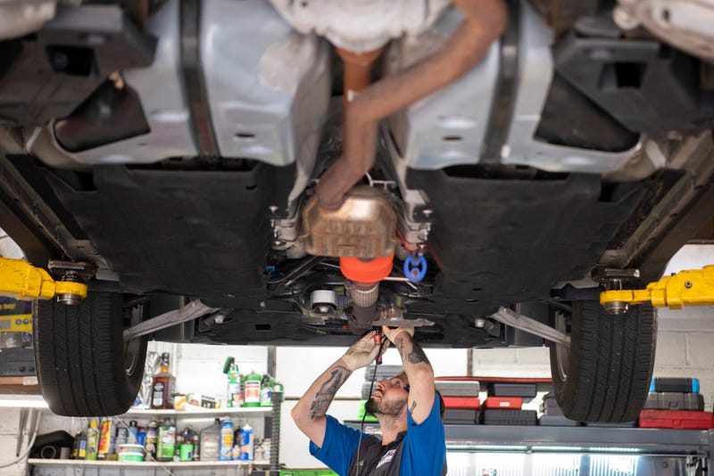 Joseph Avola etches a license plate number on a catalytic converter at Doyle's Automotive on Saturday, Aug. 27, 2022.