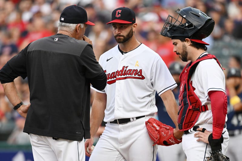 Cleveland Guardians pitching coach Carl Willis, left, talks to starting pitcher Cody Morris (36) and catcher Austin Hedges (17) during the first inning against the Seattle Mariners at Progressive Field.