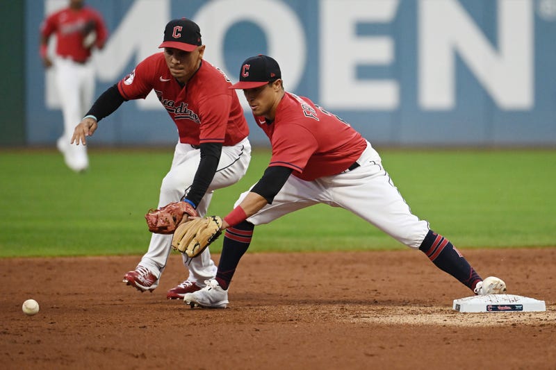 Cleveland Guardians second baseman Andres Gimenez, left, and shortstop Tyler Freeman reach for an errant throw from third baseman Jose Ramirez (not pictured) during the second inning against the Seattle Mariners at Progressive Field. 