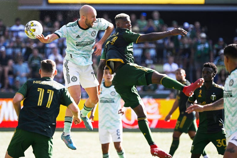 Sep 4, 2022; Portland, Oregon, USA; Atlanta United defender Andrew Gutman (15) and Portland Timbers forward Dairon Asprilla (27) battle for a header during the second half at Providence Park. The Timbers won 2-1.