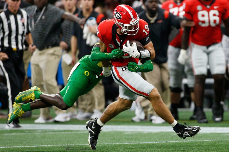 Georgia tight end Brock Bowers (19) carries an Oregon defender down the field with him during the first half of the Chick-fil-A Kickoff at the Mercedes-Benz Dome in Atlanta, on Saturday, Sept. 3, 2022.