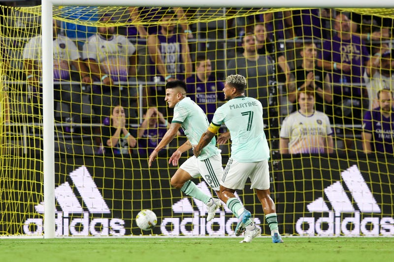 Sep 14, 2022; Orlando, Florida, USA; Atlanta United forward Josef Martinez (7) congratulates midfielder Thiago Almada (8) after scoring a goal against Orlando City in the second half at Exploria Stadium. 