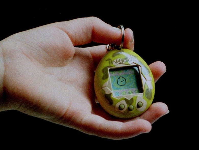 Girl holding a Tamagotchi
