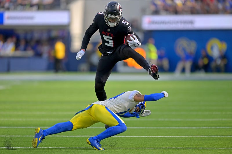 Sep 18, 2022; Inglewood, California, USA; Atlanta Falcons wide receiver Drake London (5) hurdles Los Angeles Rams cornerback Cobie Durant (14) for a first down in the fourth quarter at SoFi Stadium.