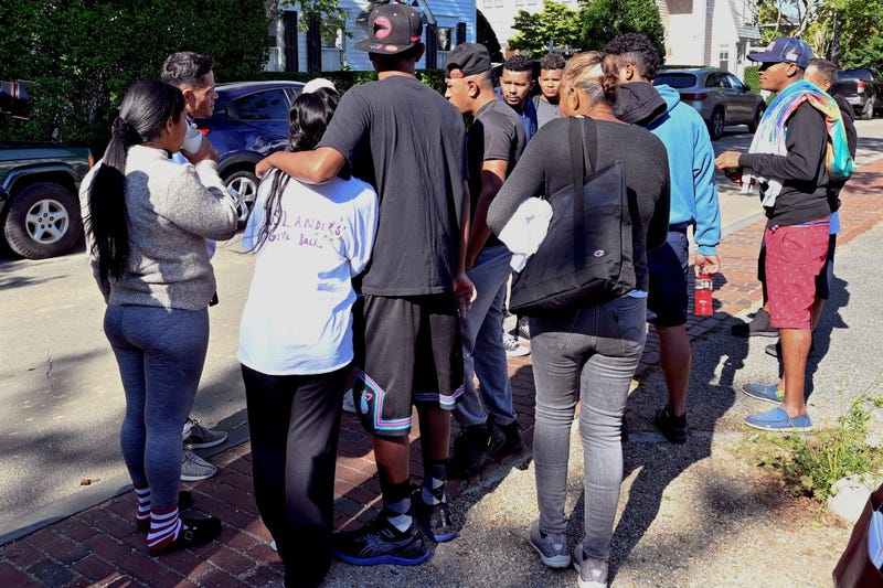 Migrants gather outside St. Andrews Episcopal Church last Thursday in Edgartown, Mass., on Martha's Vineyard.