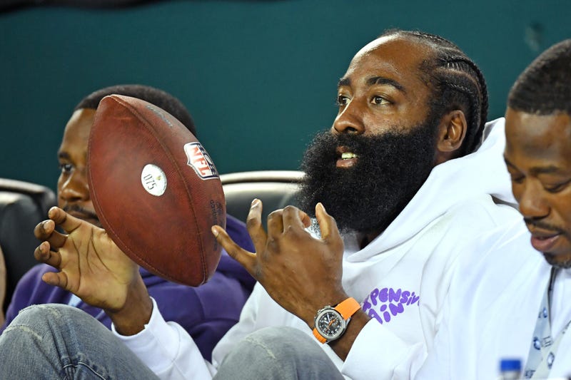 Philadelphia 76ers guard James Harden holds the football Philadelphia Eagles cornerback Darius Slay gave him
