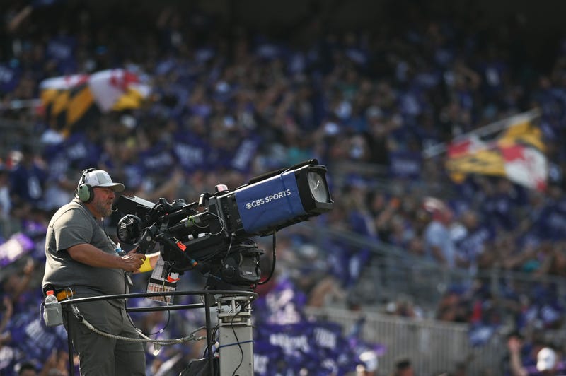 A member of the CBS Sports broadcast crew uses a video camera during the game between the Baltimore Ravens and the Miami Dolphins of a CBS at M&T Bank Stadium.