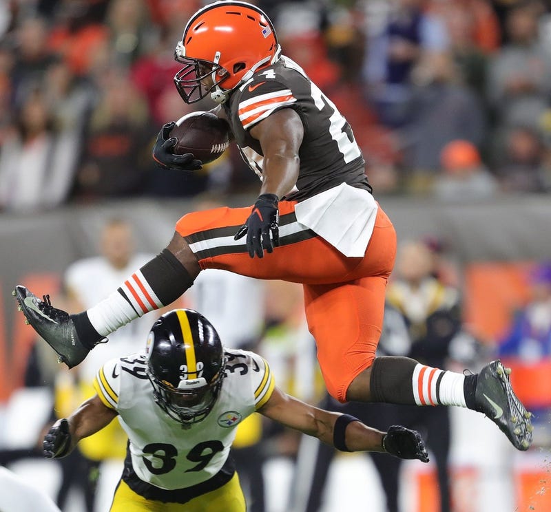 Nick Chubb leaping over Minkah Fitzpatrick