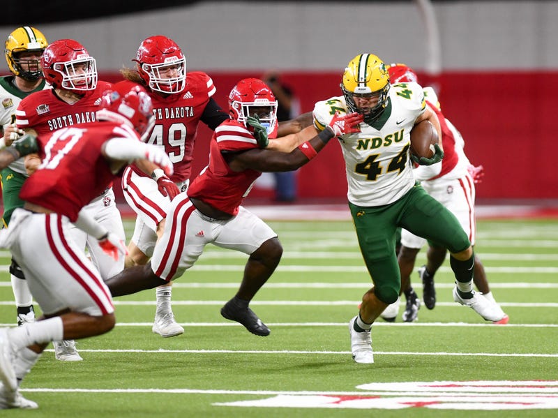 North Dakota State s Hunter Luepke holds off a South Dakota player during a football game on Saturday, September 24, 2022, at the DakotaDome in Vermillion.
