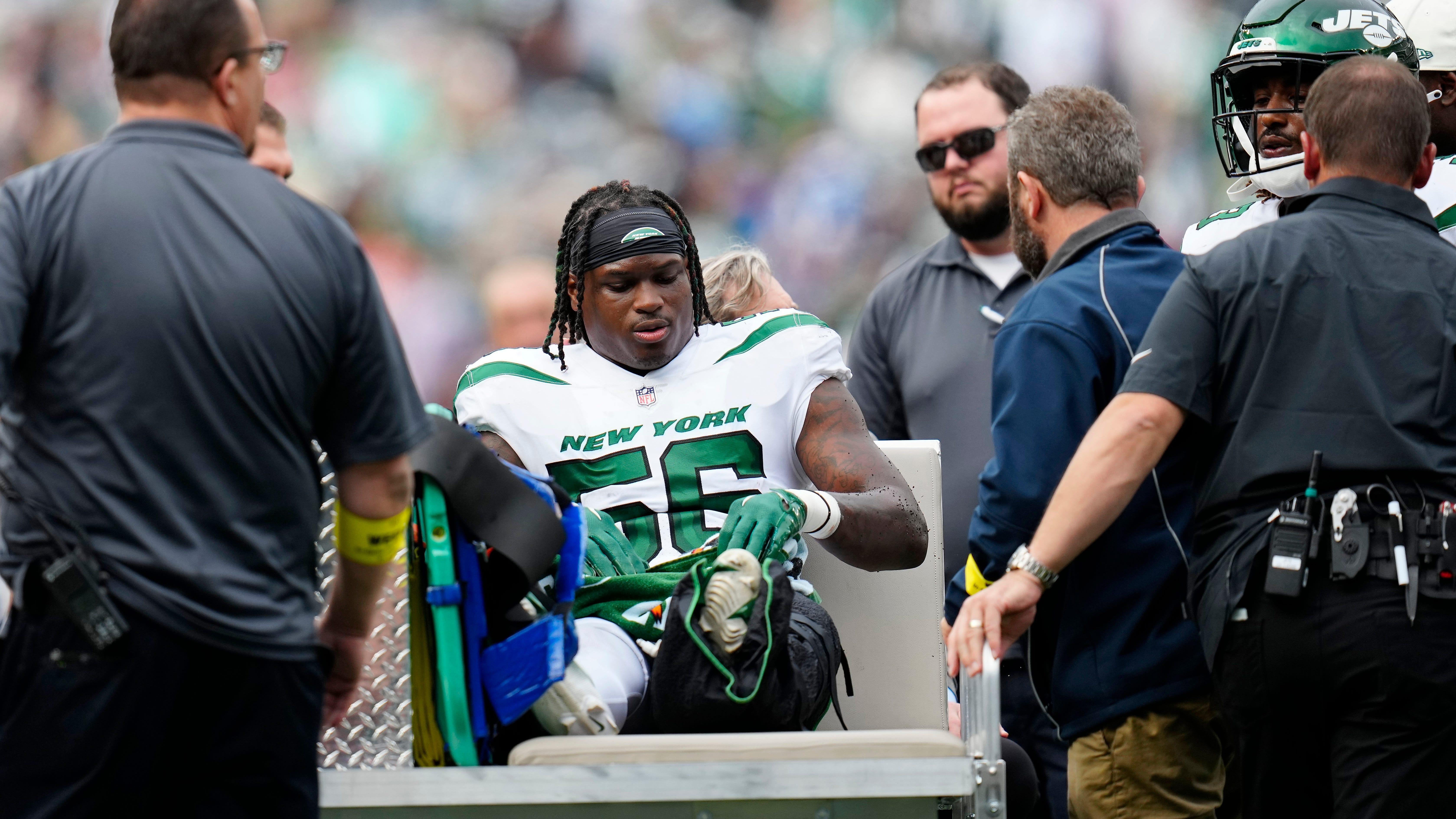 Jets' Quincy Williams carted off with left ankle injury, seen after game in walking boot