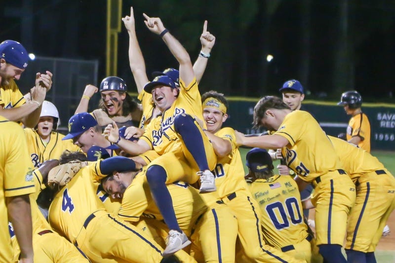 Savannah Bananas players pile on one another as they celebrates following the win over the Wilson Tobs during the CPL championship game on Friday August 5th, 2022