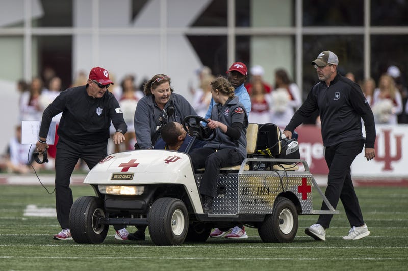 Michigan running game coordinator Mike Hart was carted off the field on a backboard and taken to a hospital for further evaluation during Saturday's game at Indiana.