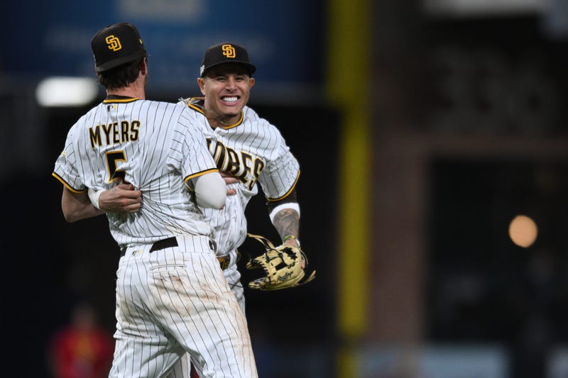 The San Diego Padres' third baseman Manny Machado (13) and first baseman Wil Myers (5) celebrate at Petco Park after defeating the Los Angeles Dodgers during Game 4 of the National League Division Series for the 2022 MLB Playoffs.