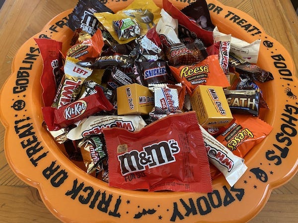 A bowl of various candy that will be handed out to trick-or-treaters on Halloween