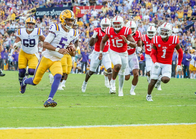 Jayden Daniels scores a touchdown as the LSU Tigers take on the Ole Miss Rebels