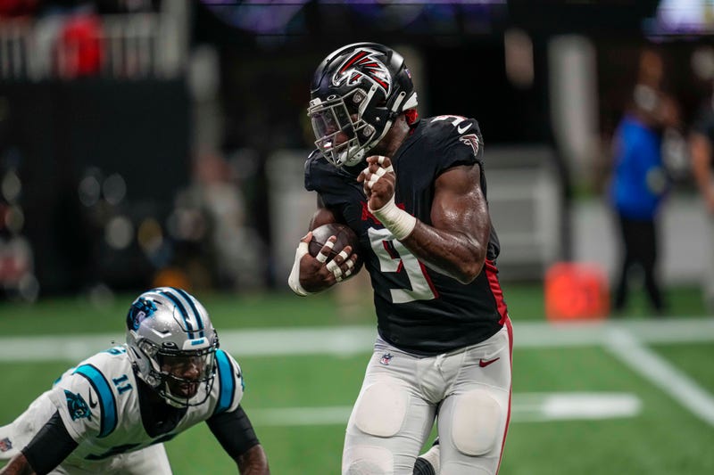 Oct 30, 2022; Atlanta, Georgia, USA; Atlanta Falcons linebacker Lorenzo Carter (9) returns a pass interception for a touchdown past Carolina Panthers quarterback PJ Walker (11) during the first half at Mercedes-Benz Stadium.