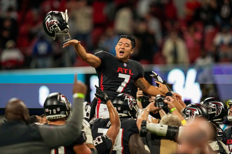 Oct 30, 2022; Atlanta, Georgia, USA; Atlanta Falcons place kicker Younghoe Koo (7) reacts as he is lifted up by teammates after kicking the game winning field goal against the Carolina Panthers during overtime at Mercedes-Benz Stadium.