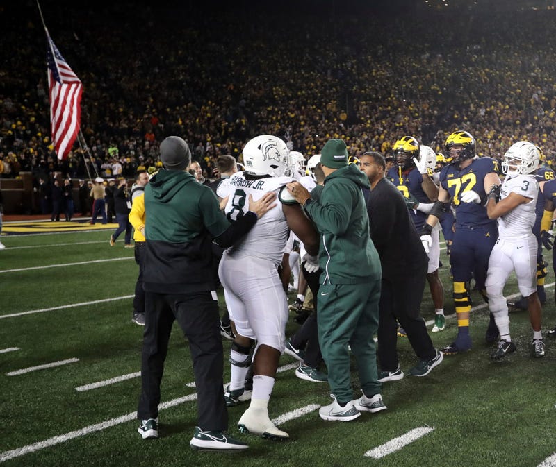 Players scuffling on the field after Michigan-MSU football game