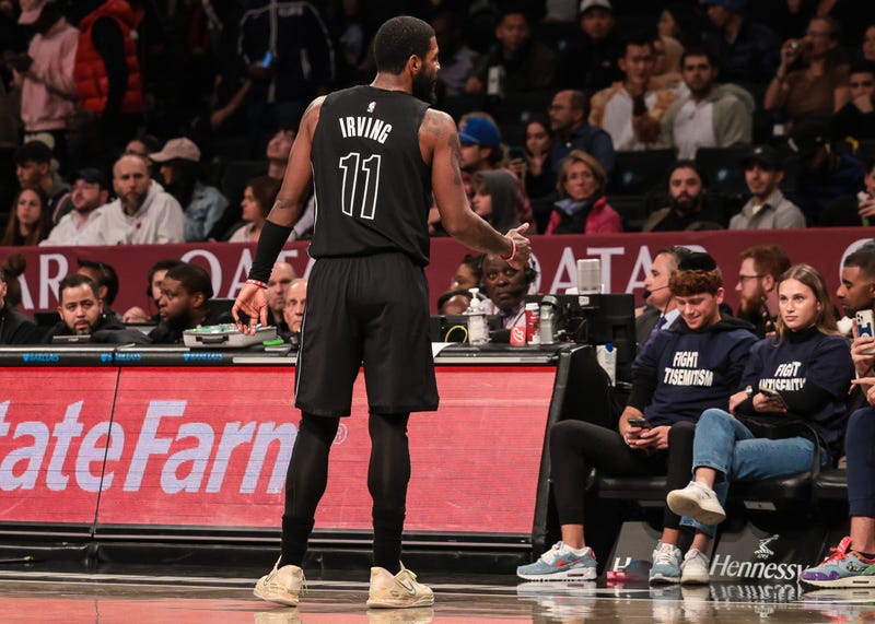 Oct 31, 2022; Brooklyn, New York, USA; Brooklyn Nets guard Kyrie Irving (11) gives a thumbs up towards fans wearing shirts with the phrase fight antisemitism during the first half against the Indiana Pacers at Barclays Center.
