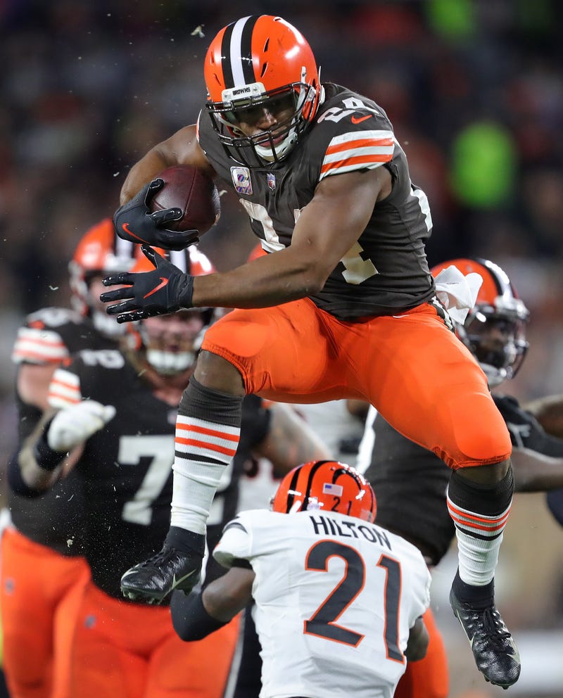 Browns running back Nick Chubb hurdles Bengals cornerback Mike Hilton as he rushes for a first-half first down Monday, Oct. 31, 2022, in Cleveland
